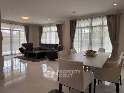 Spacious modern living room with elegant dining area and large windows