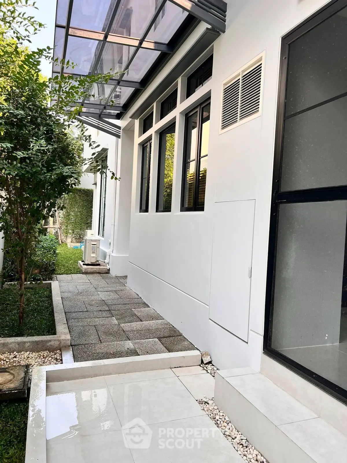 Modern exterior with sleek design and lush greenery