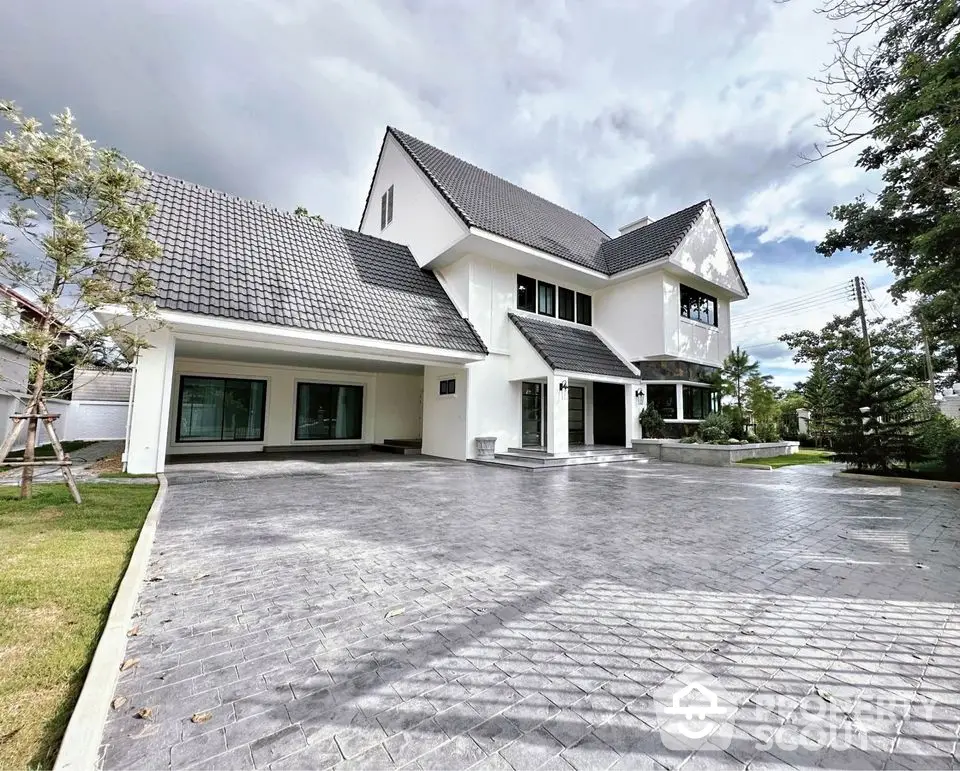 Stunning modern white house with spacious driveway and lush greenery