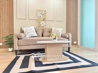 Chic modern living room with stylish sofa, decorative pillows, and elegant coffee table on a patterned rug.