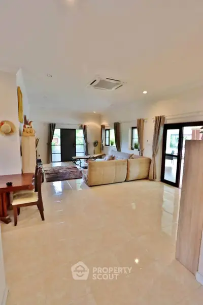 Spacious living room with elegant decor and large windows for natural light