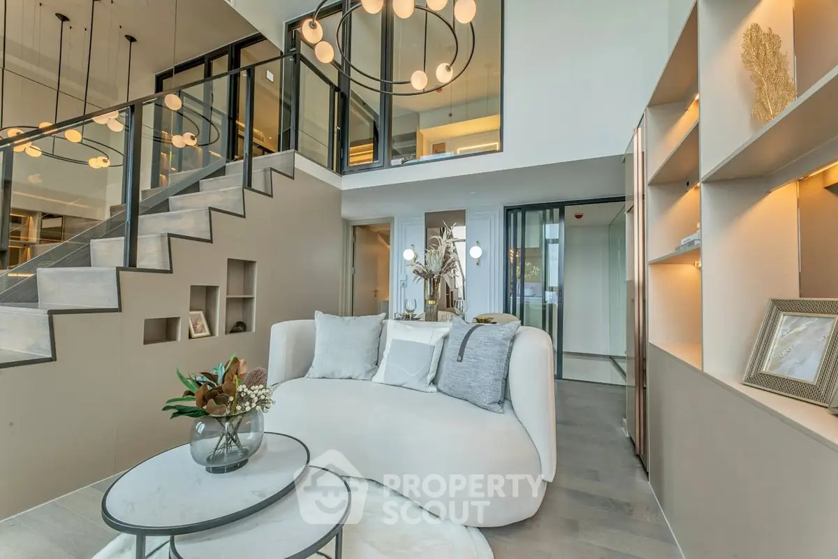 Luxurious modern living room with elegant staircase and stylish decor