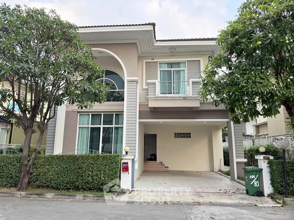 Charming two-story house with lush greenery and modern architecture