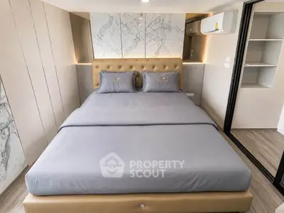 Luxurious modern bedroom with elegant decor and plush bedding in a stylish apartment.