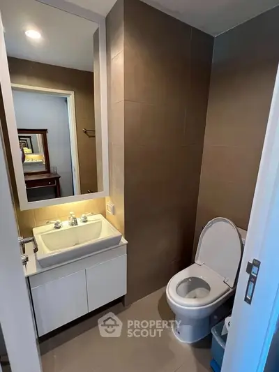 Modern bathroom with sleek fixtures and elegant lighting in a contemporary home.