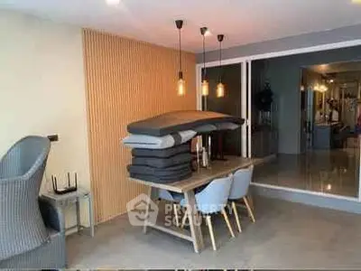 Modern dining area with stylish pendant lights and contemporary furniture in open layout.