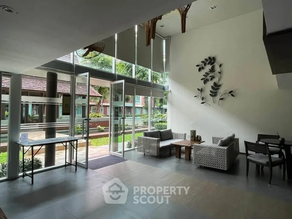 Spacious and elegant lobby with modern decor and garden view, perfect for welcoming guests.