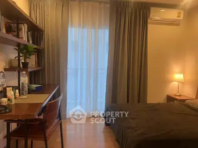 Cozy bedroom with study desk and natural light, perfect for relaxation and productivity.