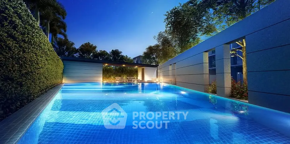 Luxurious outdoor pool with ambient lighting and lush greenery at night.