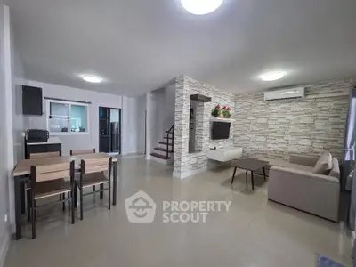 Spacious modern living room with open layout and stylish decor, perfect for family gatherings.