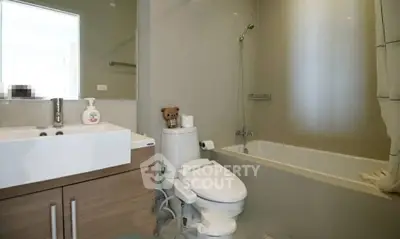 Modern bathroom with sleek fixtures and bathtub in a stylish apartment.