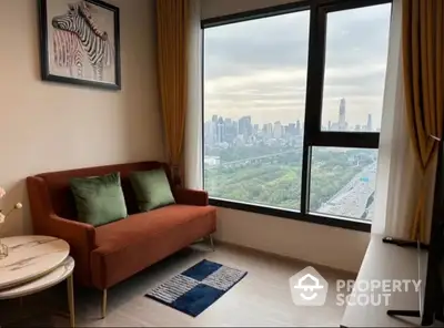 Cozy living room with modern furnishings and breathtaking city skyline view through large window, perfect for urban living.