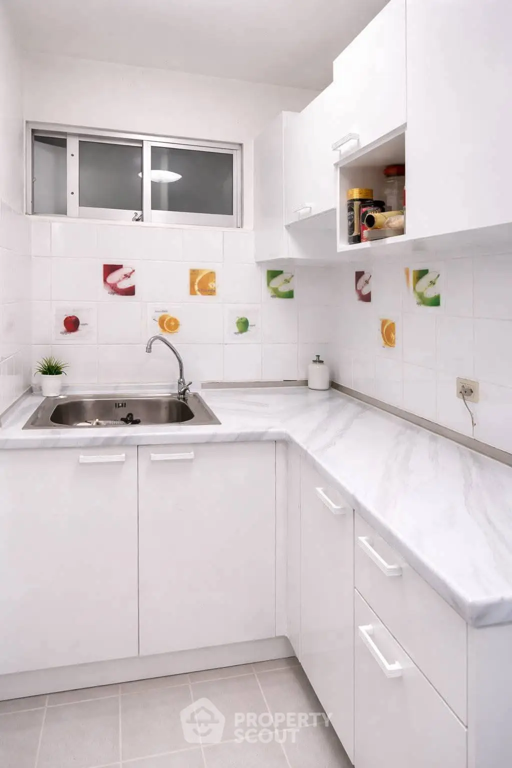 Modern white kitchen with sleek countertops and colorful tile accents