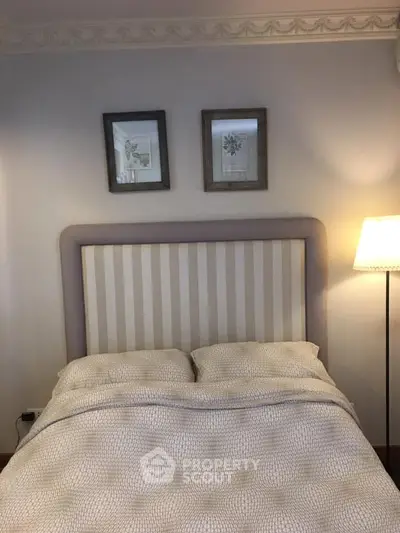 Cozy bedroom with elegant decor and soft lighting, perfect for relaxation.