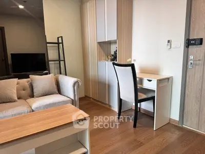 Modern living room with stylish furniture and wooden flooring in a cozy apartment.