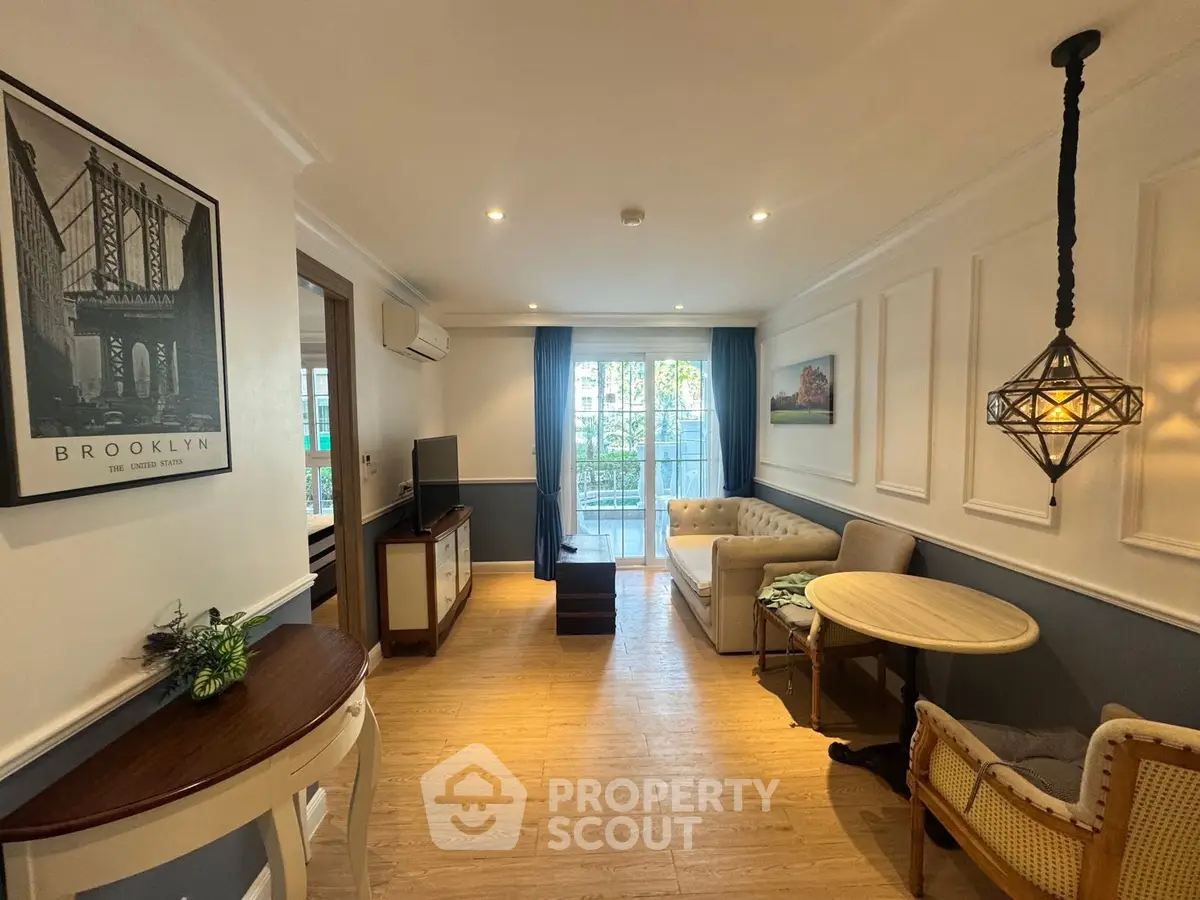 Charming living room with elegant decor and natural light, featuring cozy seating and stylish lighting.