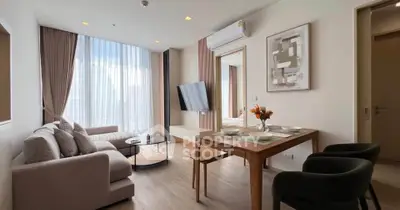 Modern living room with elegant decor, large windows, and stylish furniture in a contemporary apartment.