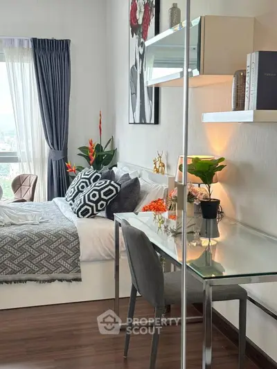 Modern bedroom with stylish decor and glass desk, featuring a large window with city view.