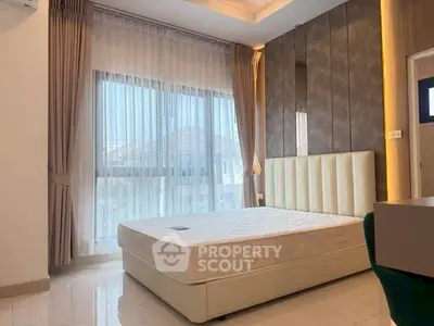 Modern bedroom with large window and elegant decor