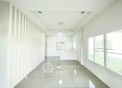Spacious and bright interior with large windows and modern tile flooring