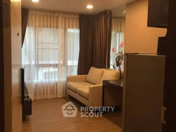 Cozy living room with elegant curtains and comfortable sofa in modern apartment.