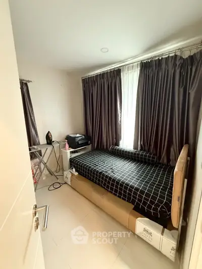 Cozy bedroom with modern decor and ample natural light