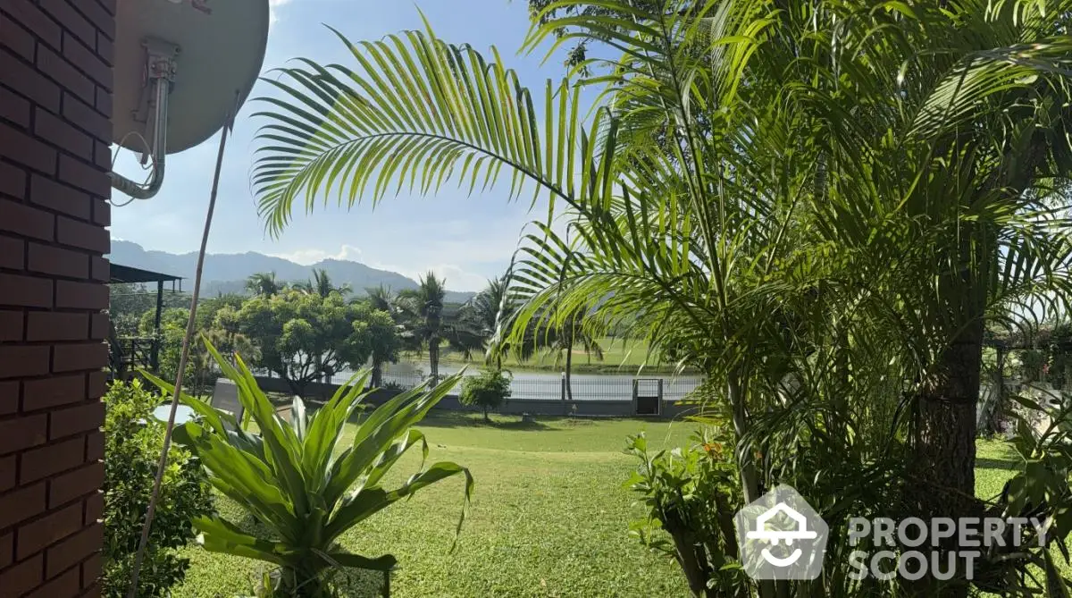 Scenic garden view with lush greenery and distant mountains, perfect for nature lovers.