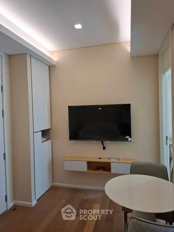 Modern living room with wall-mounted TV and stylish furniture
