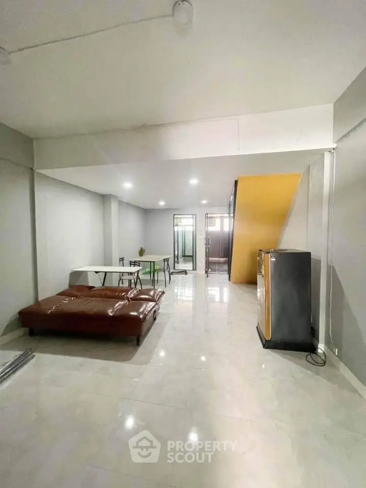 Spacious modern living area with sleek flooring and minimalist furniture