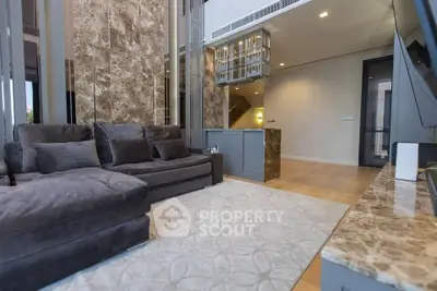 Luxurious living room with plush sofa and elegant marble accents