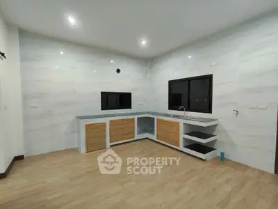 Modern kitchen with sleek cabinetry and ample counter space in a contemporary home.