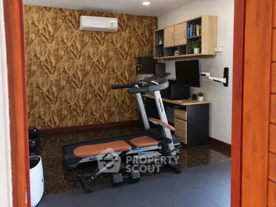Stylish home gym with treadmill and modern office setup, perfect for fitness and productivity.