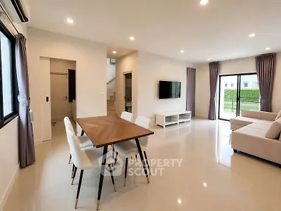 Spacious modern living room with elegant dining area and large windows for natural light.