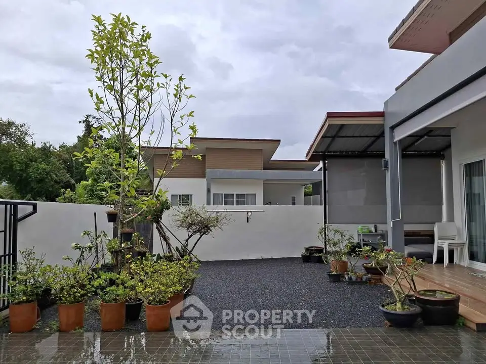 Modern home exterior with landscaped garden and potted plants