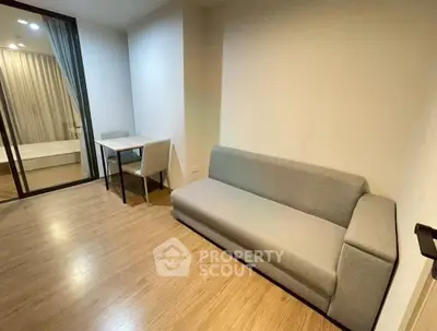 Modern living room with sleek sofa and wooden flooring in a cozy apartment