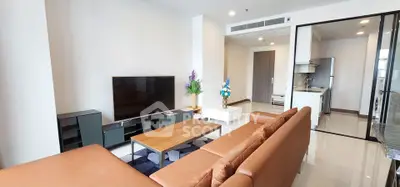 Modern living room with sleek furniture and open kitchen layout