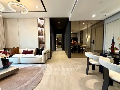 Luxurious modern living room with elegant decor and open dining area, featuring plush seating and stylish lighting.