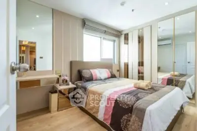 Modern bedroom with mirrored wardrobe and stylish decor in a cozy apartment.