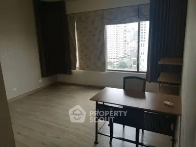 Spacious study room with city view, ideal for productivity and comfort in urban living.