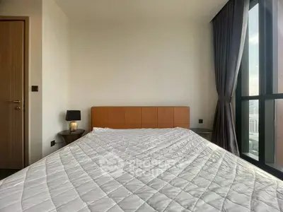 Modern bedroom with large window and stylish decor