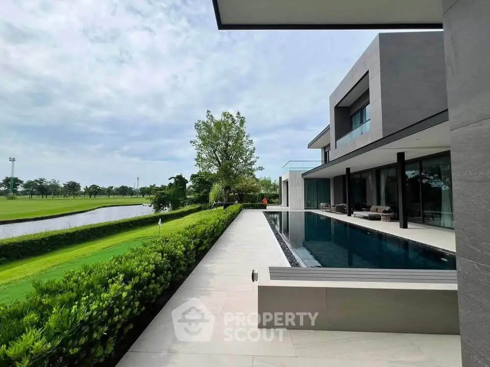 Luxurious modern villa with private pool and lush garden, offering serene views of the surrounding landscape.
