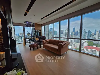 Luxurious high-rise living room with panoramic city views and elegant furnishings.