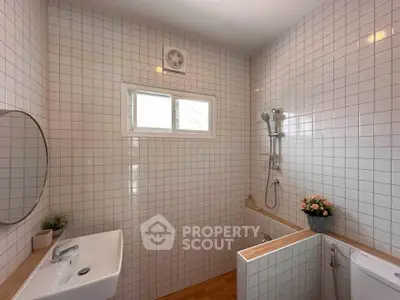 Modern bathroom with white tiles and minimalist design