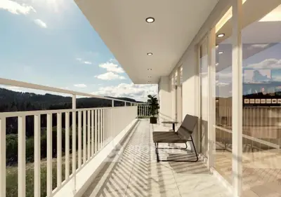 Spacious balcony with scenic view and modern seating, perfect for relaxation.