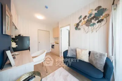 Modern living room with stylish decor and cozy seating in a bright apartment.