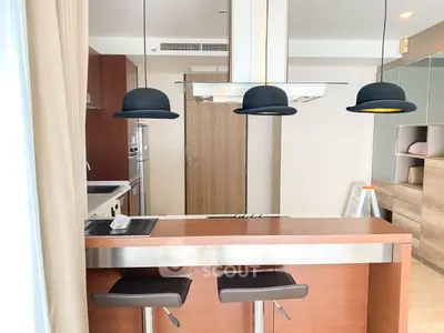 Modern kitchen with sleek island and stylish pendant lights