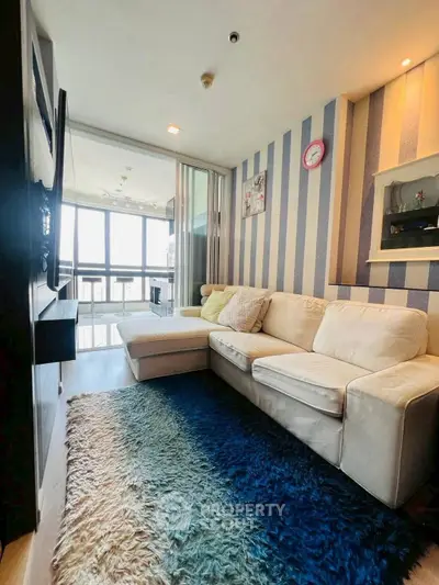 Stylish living room with modern decor and large windows offering natural light.