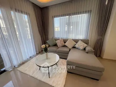 Elegant living room with modern sectional sofa and large windows for natural light.