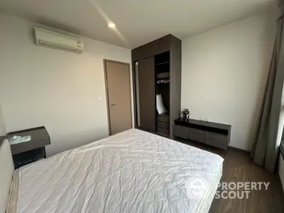 Spacious bedroom with modern wardrobe and air conditioning in a stylish apartment.