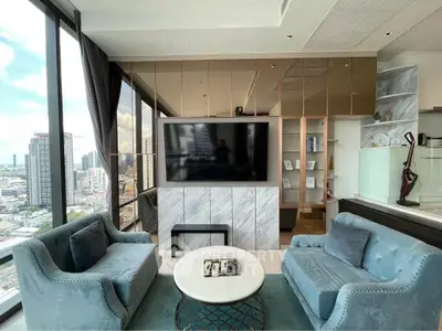 Luxurious high-rise living room with stunning city views and elegant furnishings.